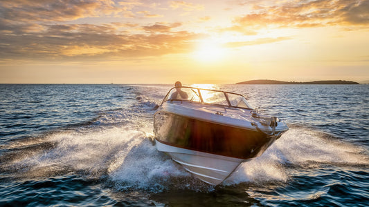 speedboat cruising on water at sunset with splashing waves
